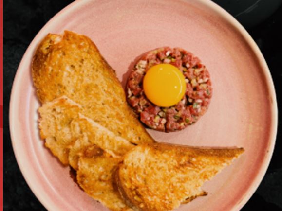 Beef tartare with an egg yolk and toasted sourdough