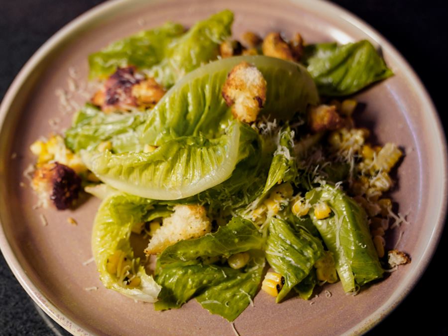 Charred corn caesar in a shallow bowl