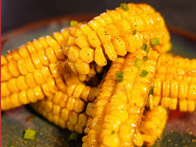 Quartered corn ribs, seasoned and charred
