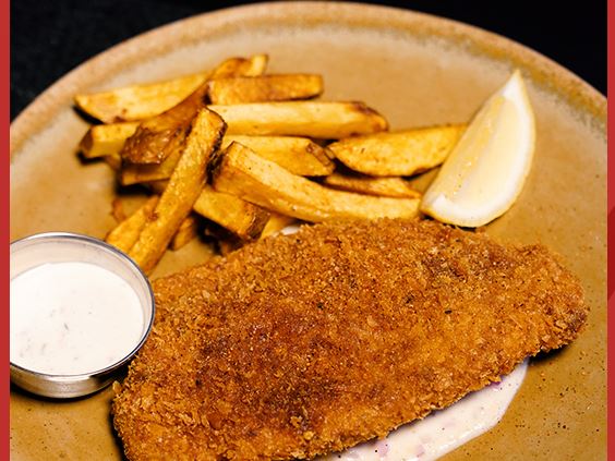 Panko sea bass with fries, tartare sauce and a lemon wedge