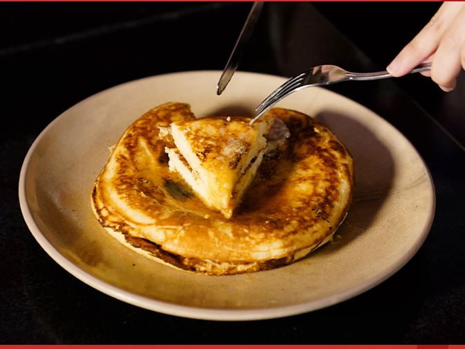 A buttermilk pancake with butter melting into it