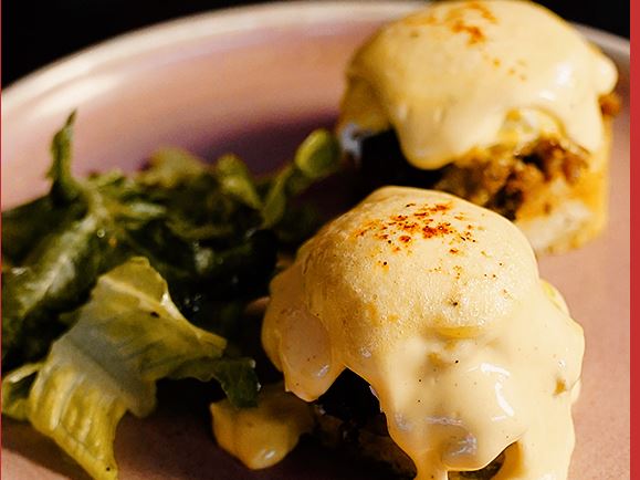 Poached eggs under chilli hollandaise on brioche