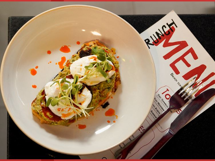 Smashed avocado and poached eggs on toasted sourdough