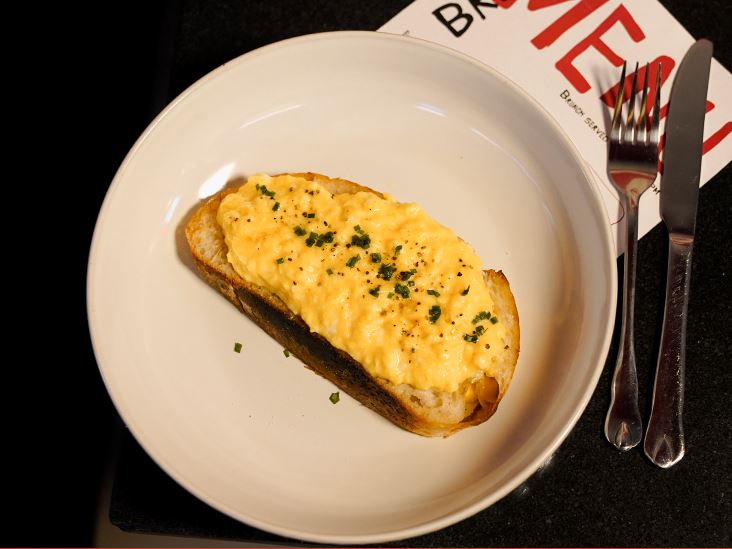 Soft scrambled eggs and chives on toasted sourdough