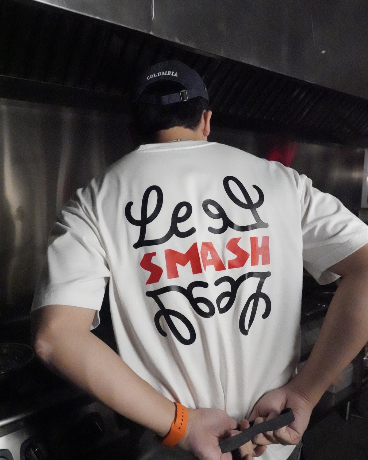 The Le SMASH wordmark on the back of a staff shirt