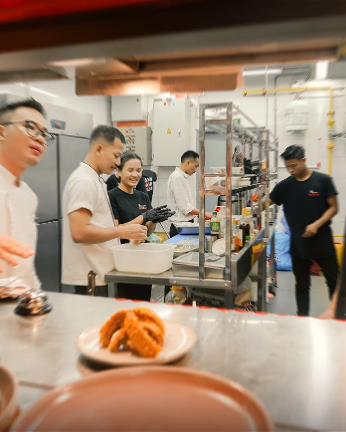 The kitchen seen through the pass window mid-service