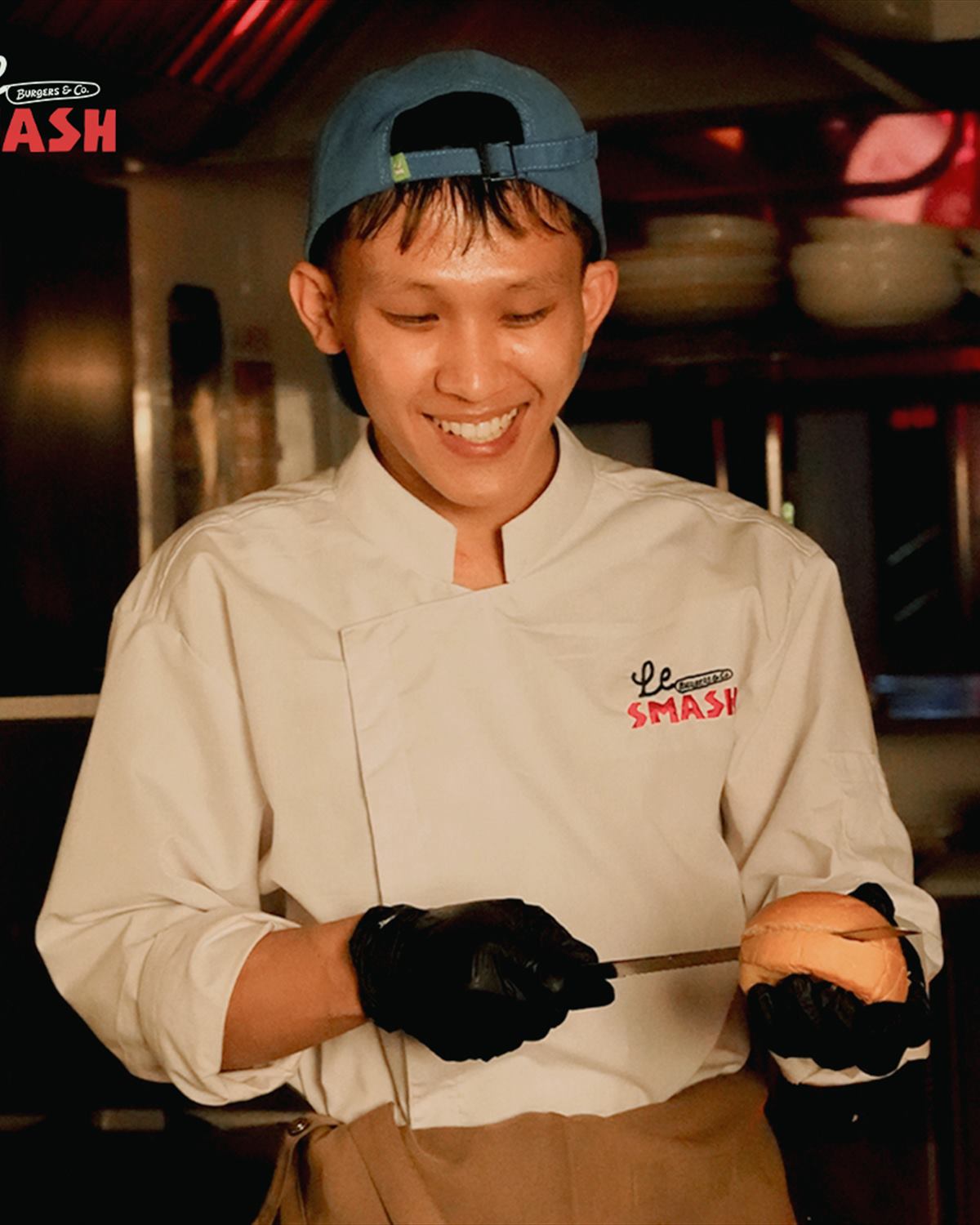A cook in whites at the plancha, mid-service