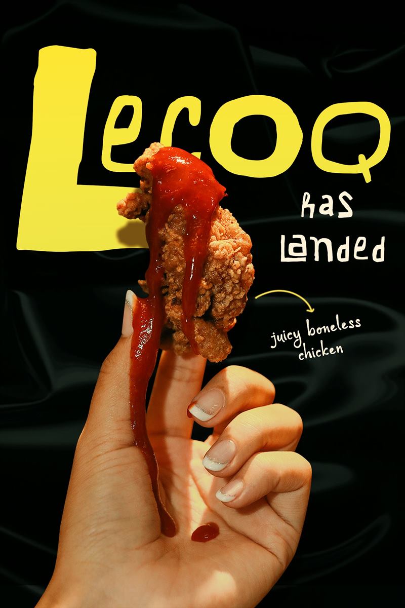 Le COQ has landed — a hand holding a piece of buttermilk chicken