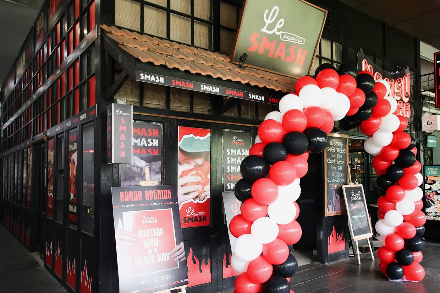 A red, black and white balloon arch outside the shopfront on opening day