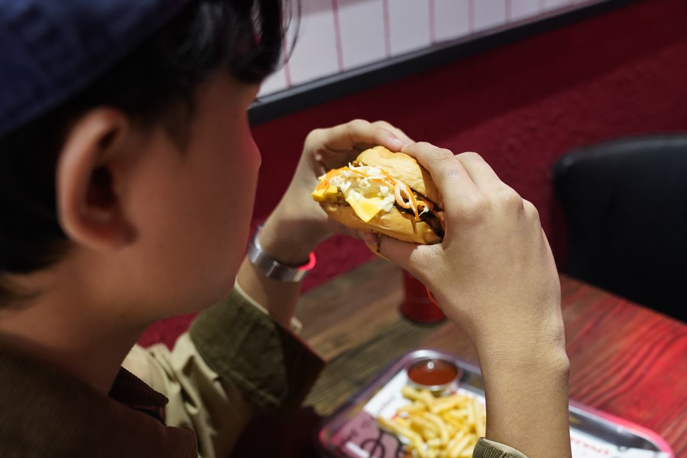 A guest eating at the booth, tray in front of them