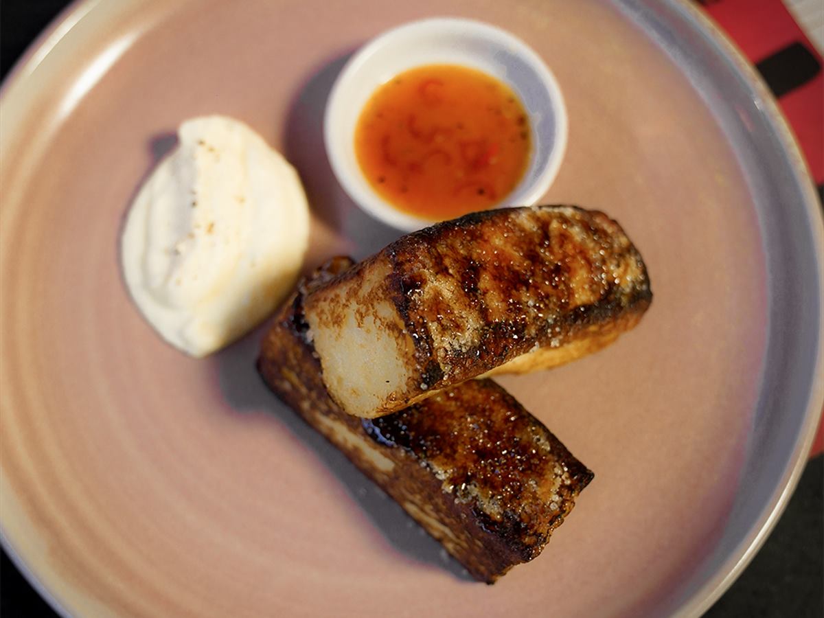 A plated dish with a dipping sauce