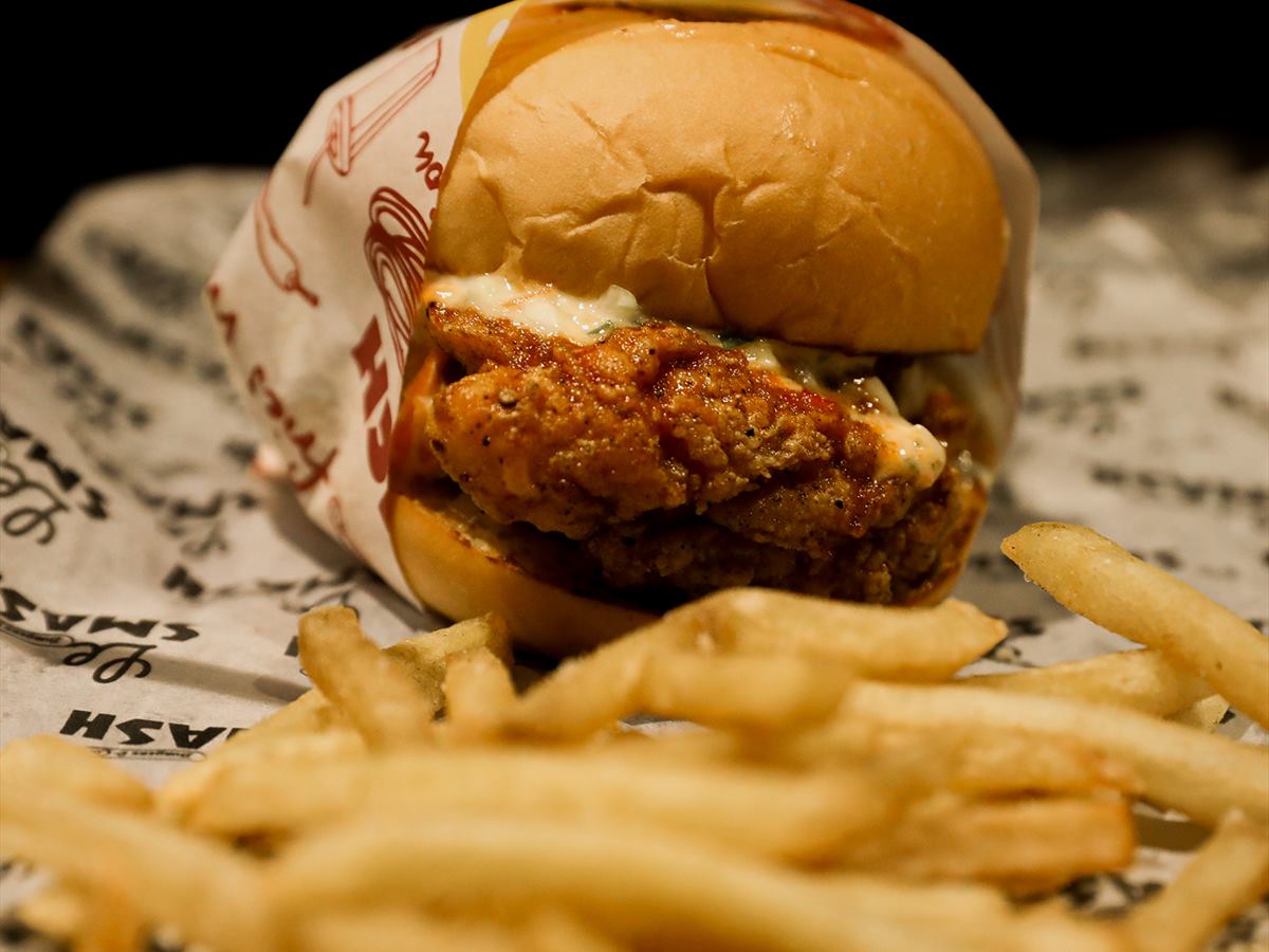 The chicken burger with frites in the foreground