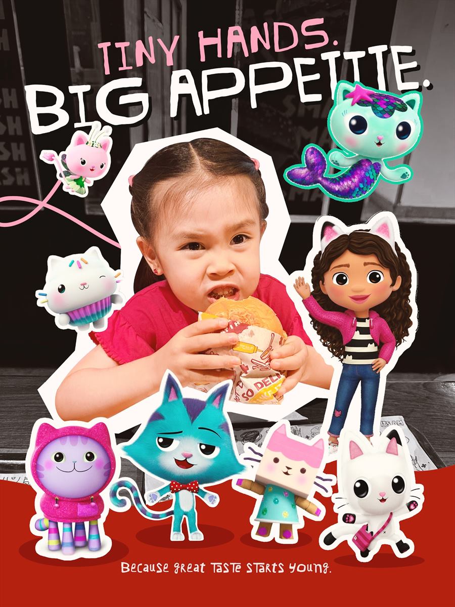 Tiny hands, big appetite: a child eating a burger among stickers